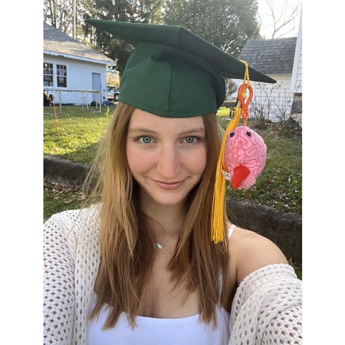 Brain key chain on graduation cap