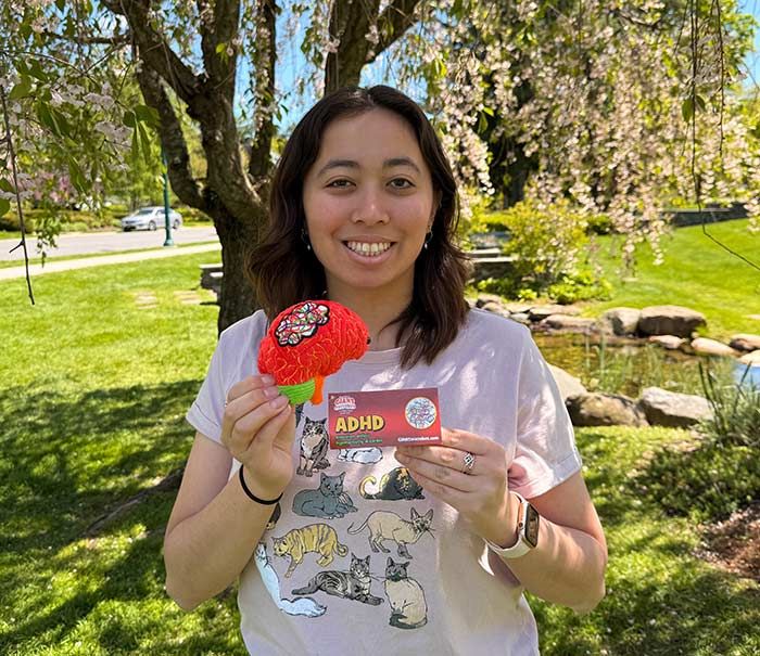 Model holding ADHD plush
