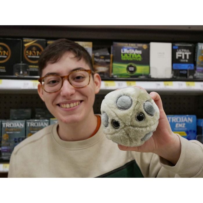 Holding HPV plush with condoms