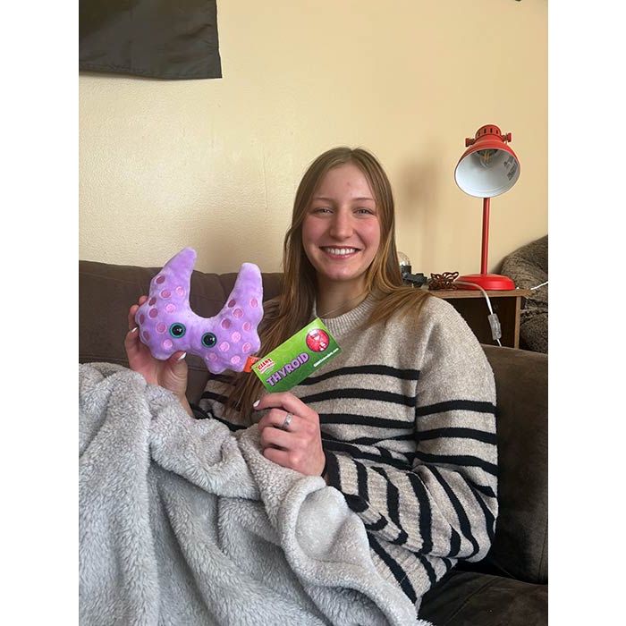 Model holding Thyroid on couch Model holding Thyroid on couch