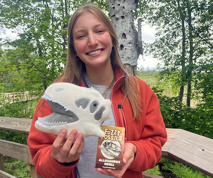 Allosaurus plush in hand