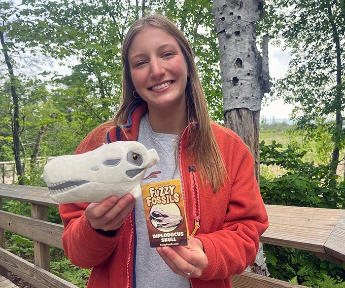 Diplodocus plush in hand