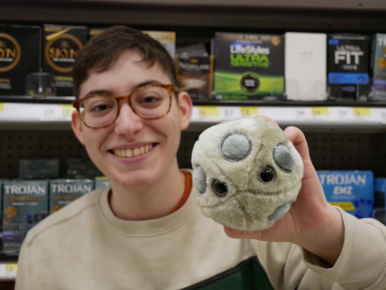 Holding HPV plush with condoms