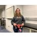 Model holding Uterus plush in class